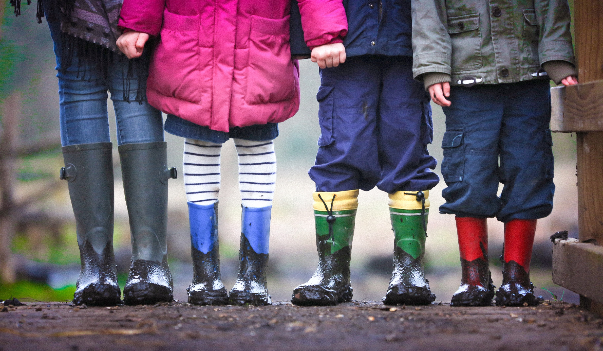 Four children in wellies stand in a row. Ben Wicks/Unsplash