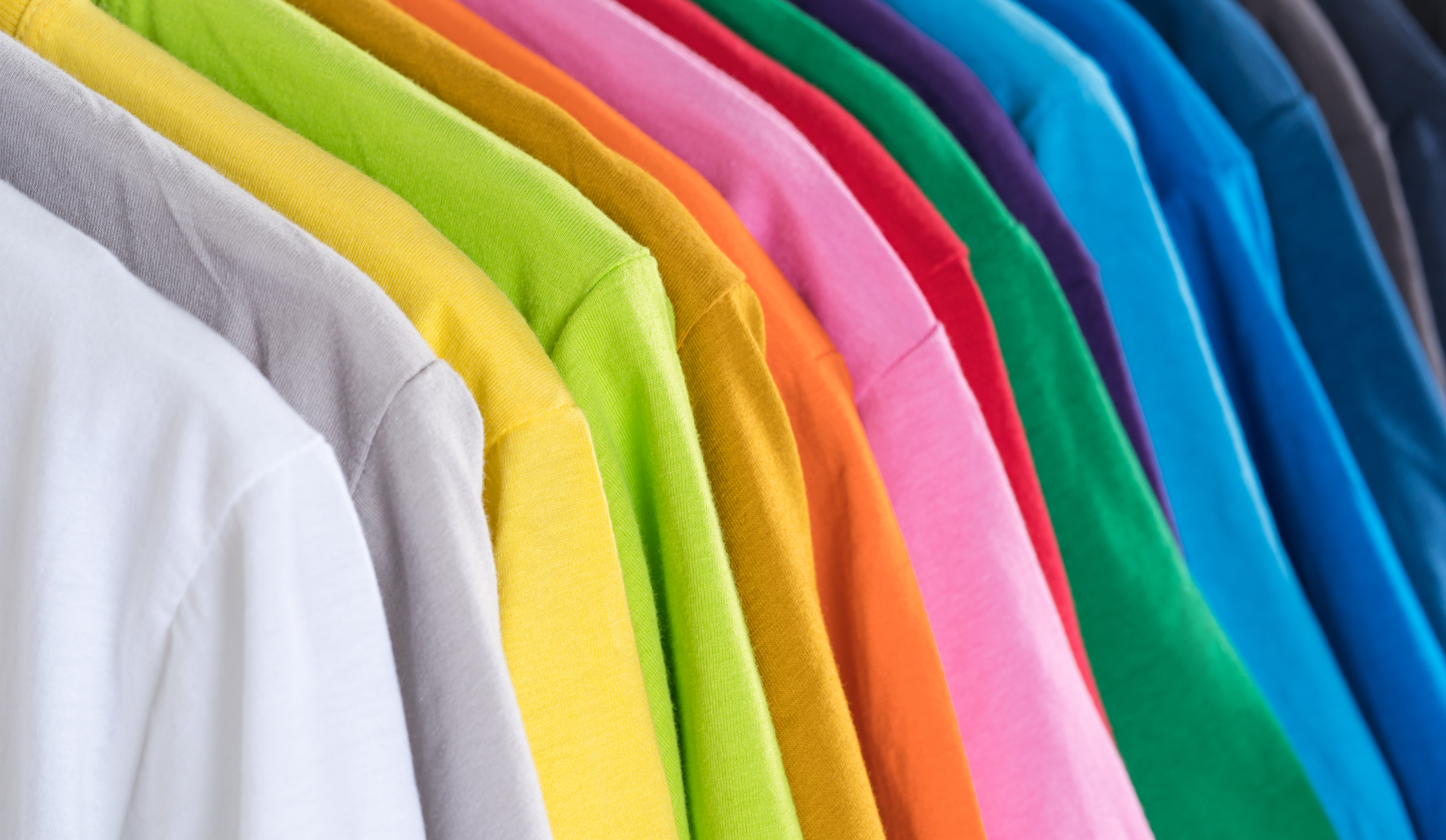 A row to colourful t-shirts. Sorapong Chaipanya/Unsplash