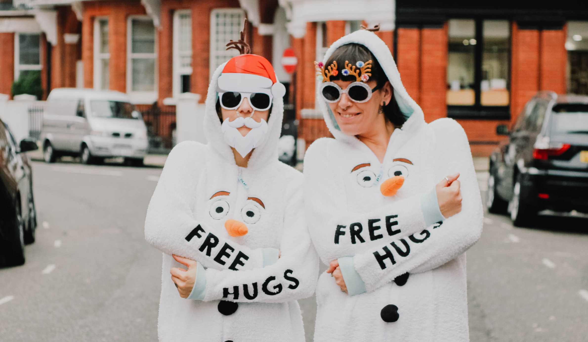 Two women dress up for Christmas Jumper Day. Toa Heftiba/Unsplash